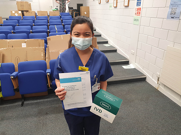 A nurse with her COVID-19 lateral flow testing kit