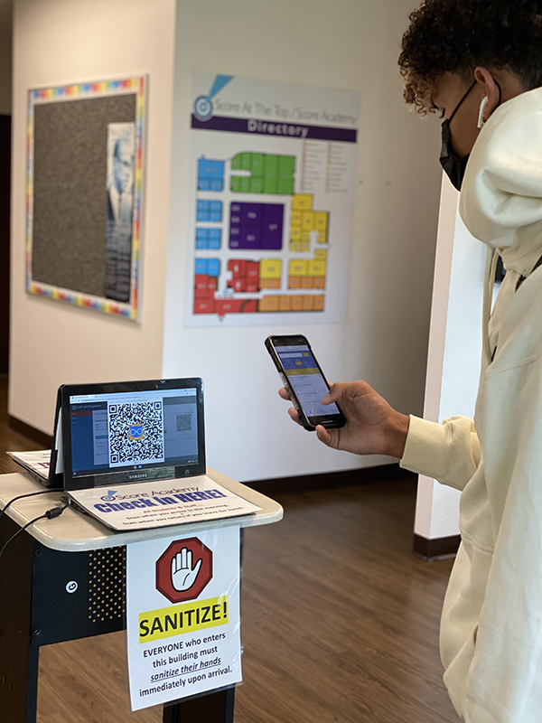 A student scanning into school with his CAT QR mobile app